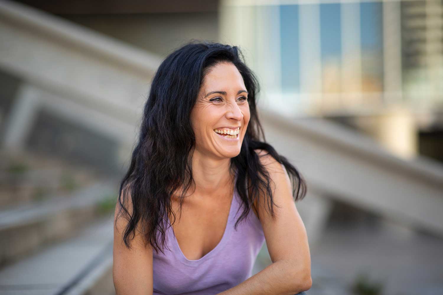 Woman smiles while thinking of her decision to purse IVF after 40 at Ember Fertility Center | Laguna Hills & Orange County, CA