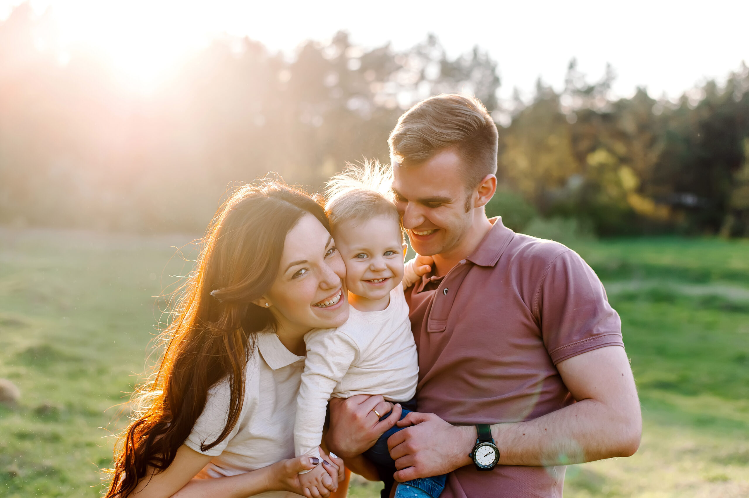 Couple smiling at their baby conceived with a gestational carrier | Envita Fertility Center, Orange County