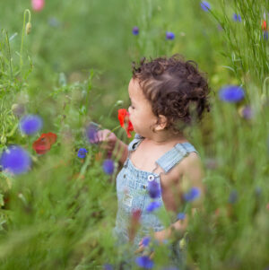 IVF baby sniffs flower | Ember Fertility Center