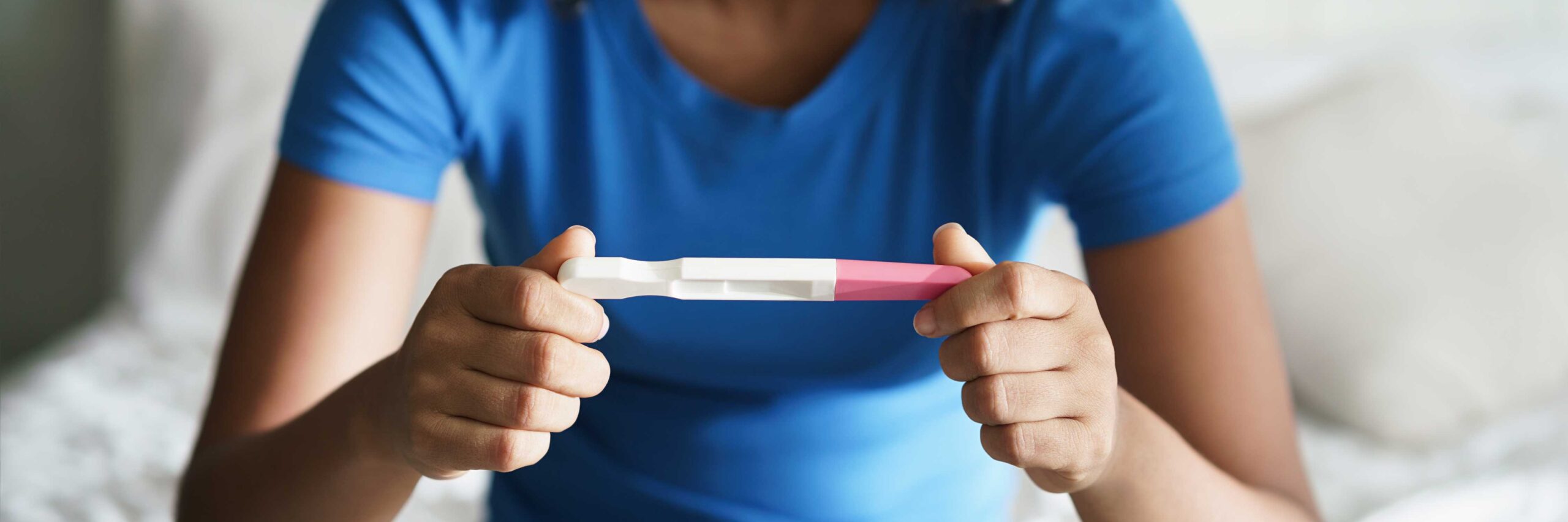 Woman experiencing secondary infertility looks at negative pregnancy test | Ember Fertility Center | Laguna Hills & Orange County, CA